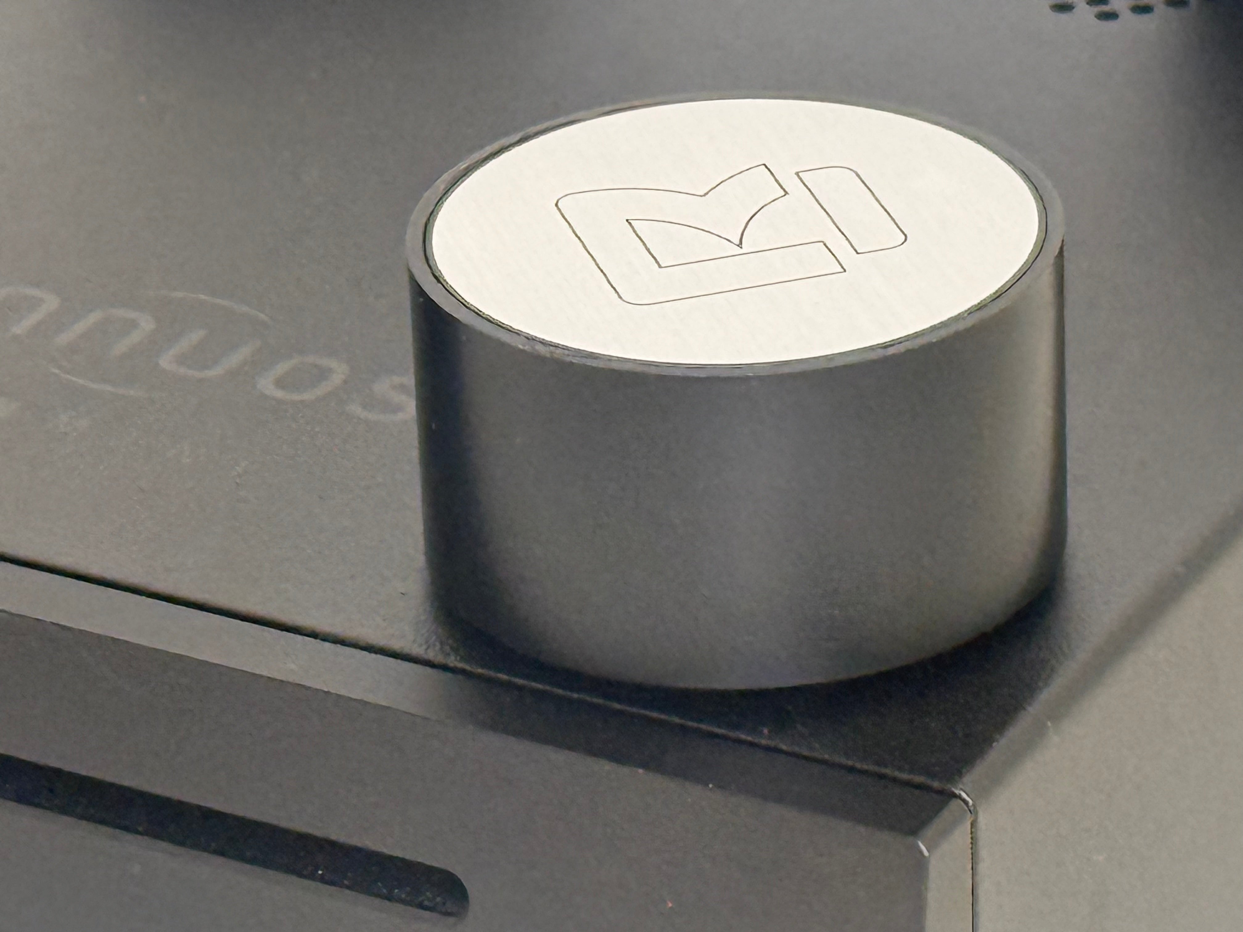 Ground coffee container on box, black cylinder with white logo top