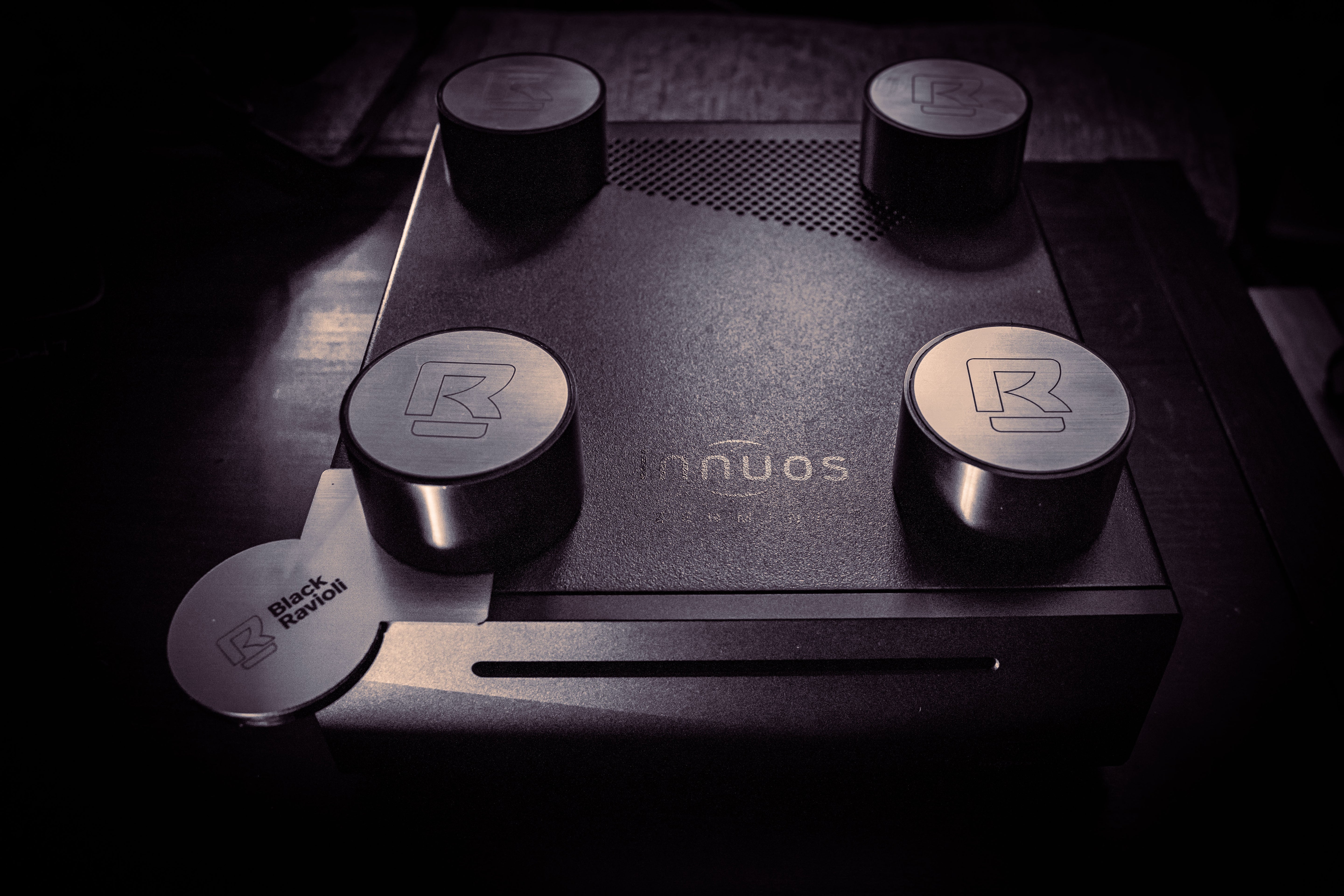 Tabletop ground game with four round metal caps and logo pad